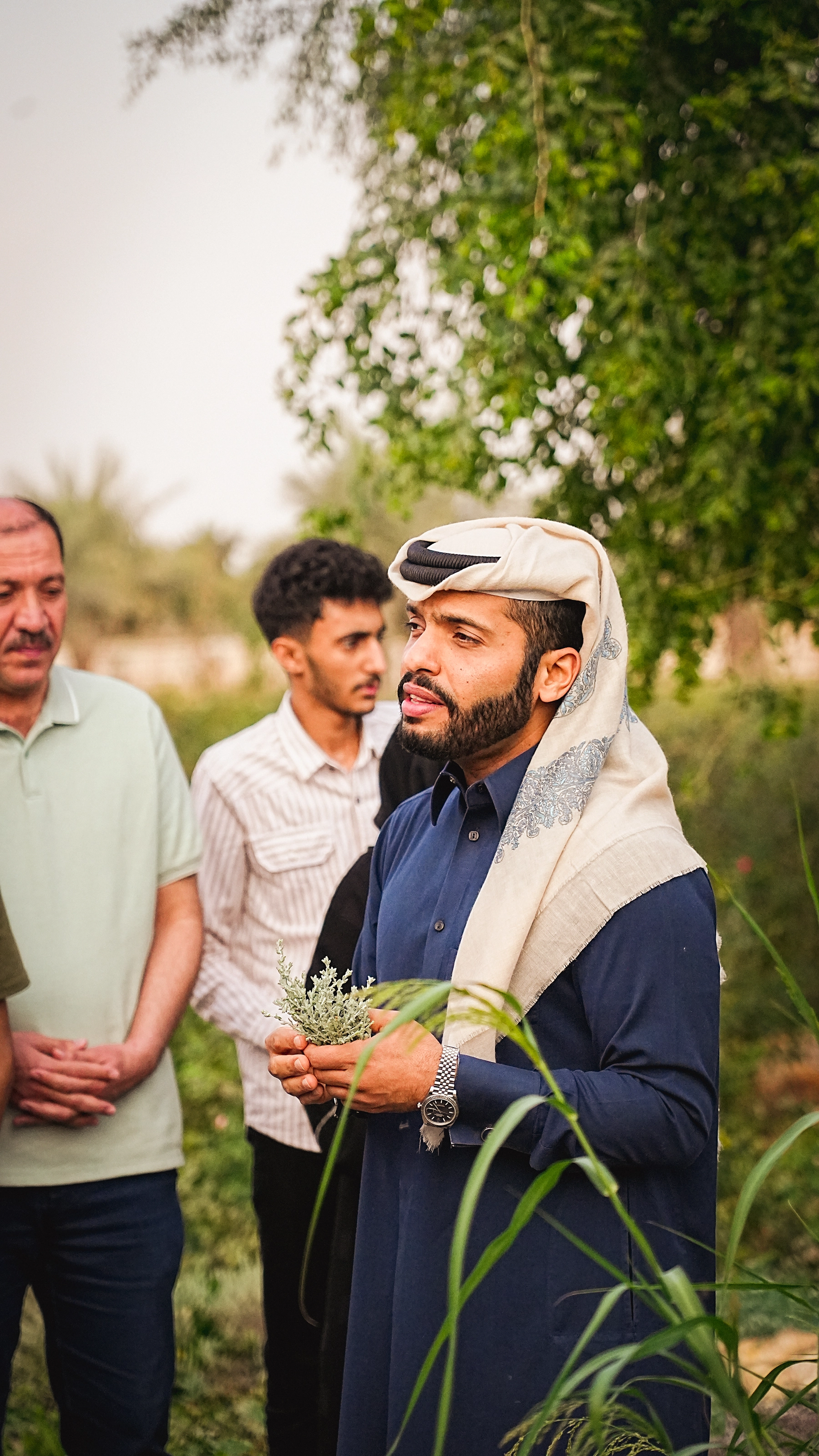 Mohammed outdoors tending plants